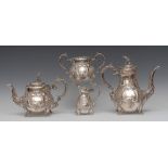 A Victorian Rococo Revival silver four piece tea and coffee service, comprising tea pot, coffee pot,