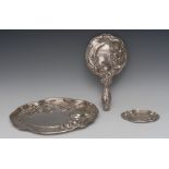 An Art Nouveau silver shaped oval dressing table tray, embossed with stylised flowers, wavy border,