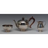 A composed George II style silver three piece bachelor's tea service,