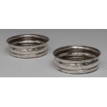 A pair of George III Scottish silver bowed circular wine coasters,