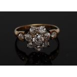 A diamond daisy head cluster ring, central round brilliant cut diamond, approx 0.