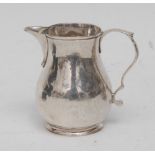 A George II silver sparrow beak pitcher cream jug, scroll-capped handle, skirted base, 7cm high,