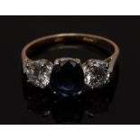 A sapphire and diamond trilogy ring, central oval blue sapphire 1.