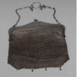 An early 20th century silver mesh evening bag, sphere finials to clasp, suspension chain, 15.