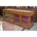A large walnut veneered shop counter, pierced and shaped gallery,