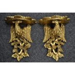 A pair of modern gilt wood wall brackets as stylized eagles perched on branches.