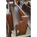 A pitch pine church pew with octagonal supports 330cm long.