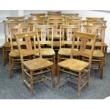 Twenty ash and elm chapel chairs fitted with hymnal ledge, curved top rail,