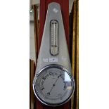 A 1950's barometer, by Sestrel, signed, silvered circular dial, surmounted by a thermometer,