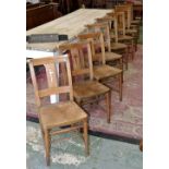 Nine ash and elm chapel chairs fitted with hymnal ledge, curved top rail,