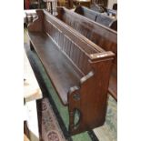 A pitch pine church pew with octagonal supports 267cm long.