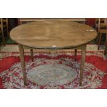 Circular fruitwood table, plank top, tapering square legs, 76cm high, 131cm diameter.