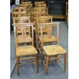 Twenty ash and elm chapel chairs fitted with hymnal ledge, curved top rail,