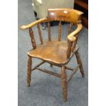 A beech and elm Captain's chair, turned supports, saddle seat, turned legs and stretchers.