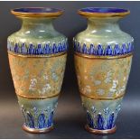 A pair of Royal Doulton baluster vases, with moulded foliage and floral decoration in gold,