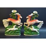 A pair of Staffordshire flatbacks, leaping stags, gilt line bases, c.