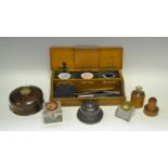 A salt glazed inkwell; a pewter inkwell; a brass topped inkwell; another ; an oak ink stand ;