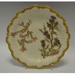 A Royal Worcester fluted shaped circular plate, printed and painted with thistles,