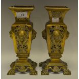 A pair of Victorian spill vases, cast with profiles of a classical Maiden to panelled sides,
