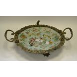 A Cantonese gilt metal mounted dish, typically decorated with butterflies and peonies,