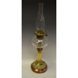 An Art Nouveau brass and copper oil lamp, clear glass reservoir, c.