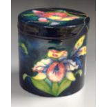 A Moorcroft Pottery Orchid pattern jar and cover with paper label