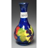 A Moorcroft Hibiscus pattern vase, original label,