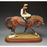 A horse and jockey figure,