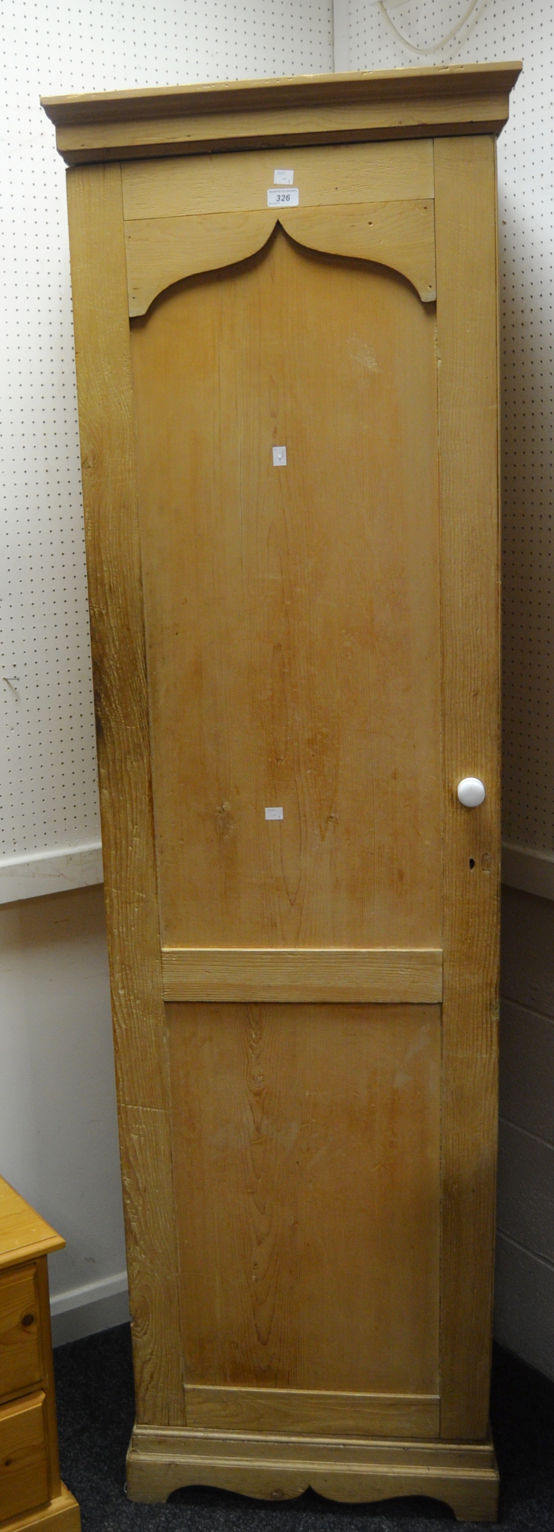 An early 20th century pine hallrobe, single cross banded shield shaped paneled door,