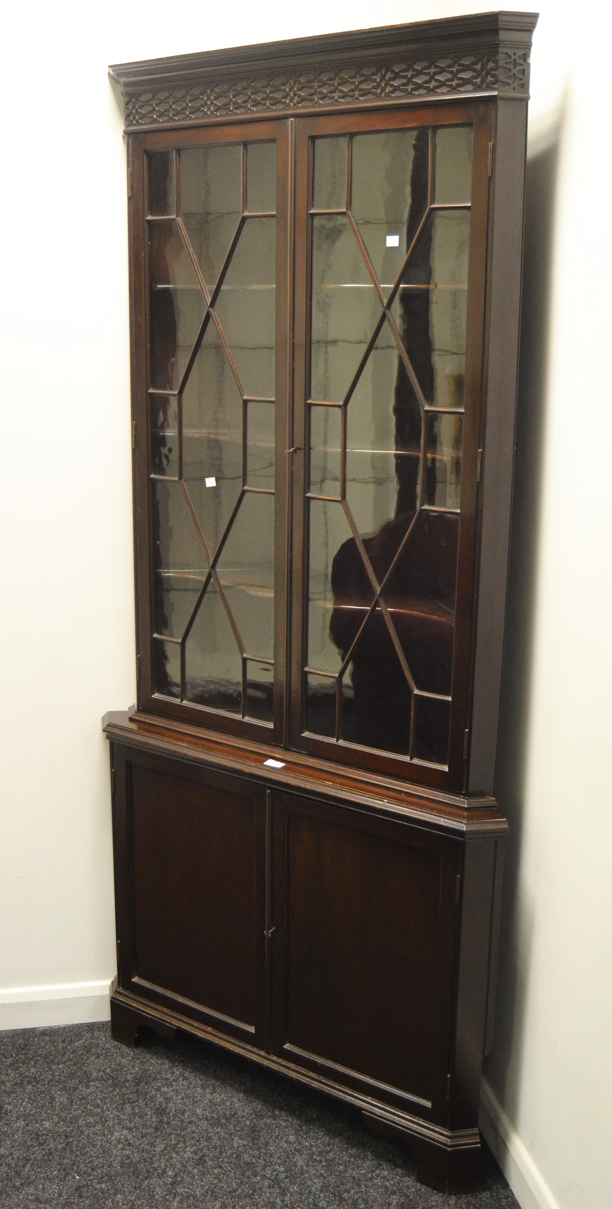 An early 20th century free standing corner unit , carved frieze,