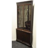 An early 20th century free standing corner unit , carved frieze,