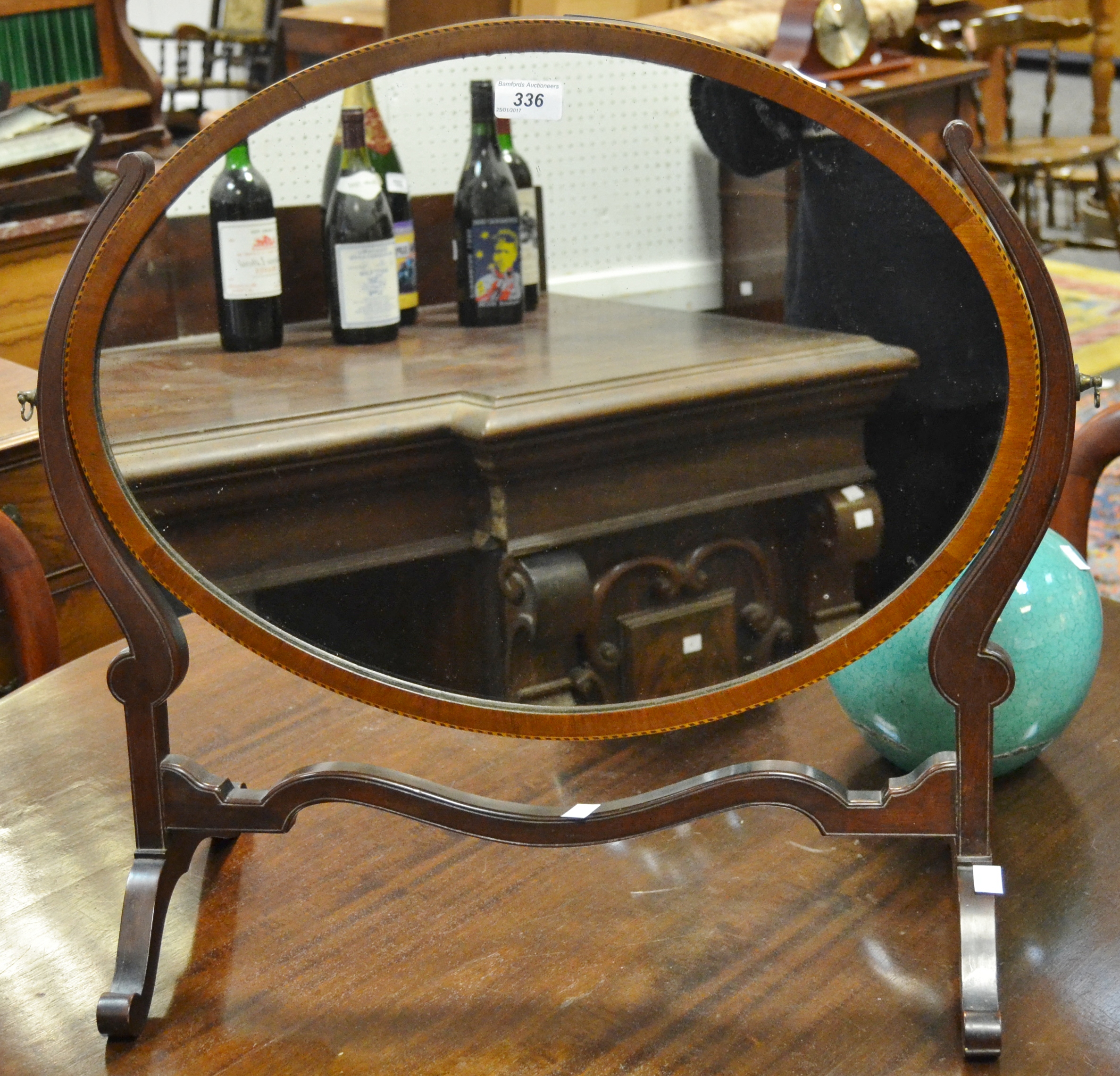 An Edwardian mahogany framed, oval dressing mirror,