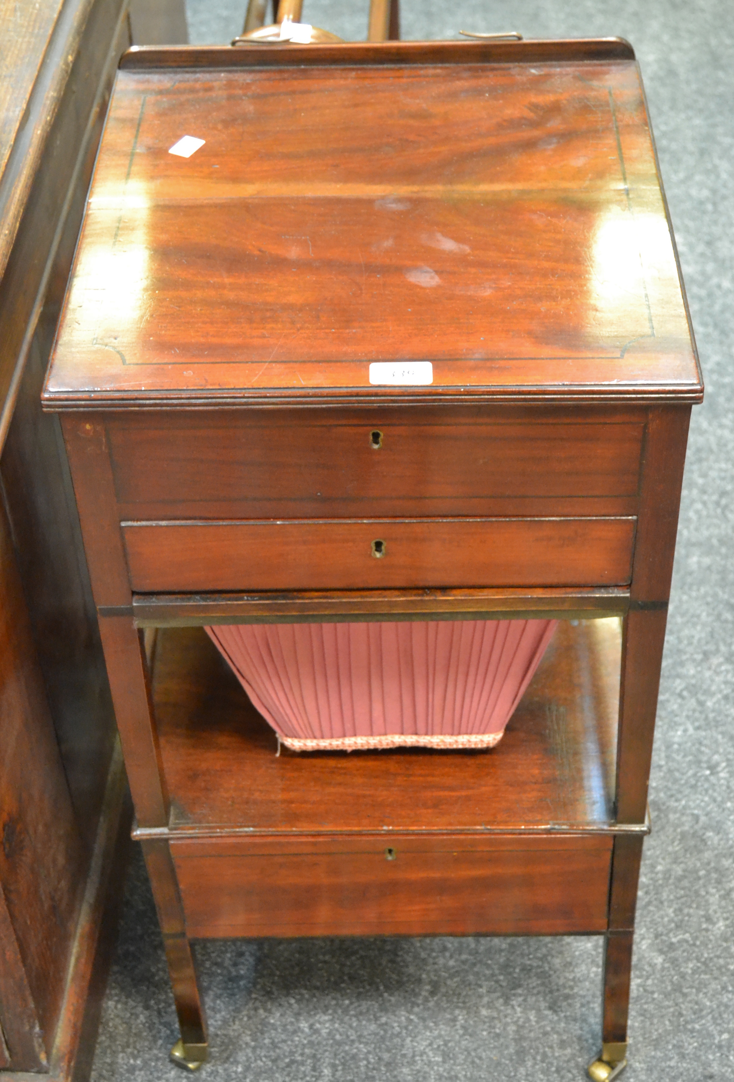 An early-19th century mahogany sewing box, hinged music stand top enclosing storage,