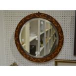 A circular mahogany, satinwood inlaid, mirror c.