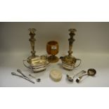 A pair of silver plated candlesticks; an old Sheffield Plate cream jug; sucrier;