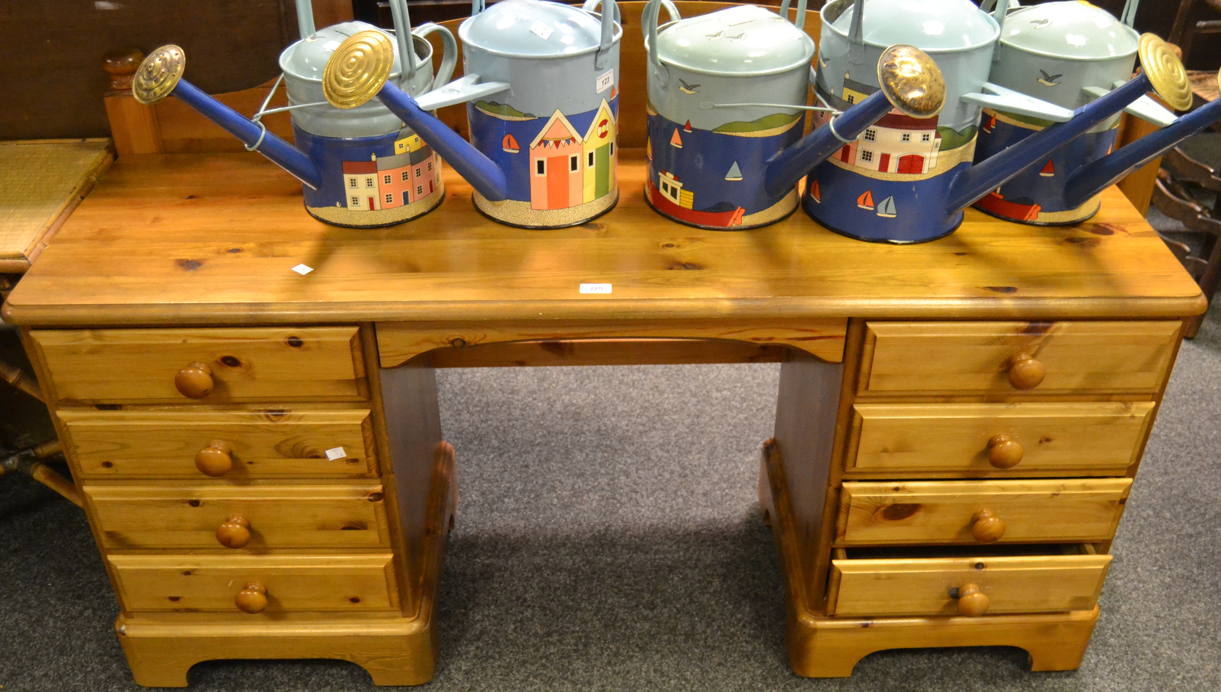 A pine Ducal kneehole desk/dressing table, two sets of four drawers,