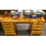 A pine Ducal kneehole desk/dressing table, two sets of four drawers,