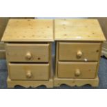 A pair of contemporary pine bedside cabinets, two drawers,