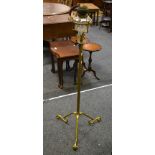 A Victorian wrought iron standard oil lamp, with telescopic action, clear glass reservoir,
