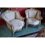 A pair of large French Louis XV style giltwood armchairs, pierced and carved leafy scroll borders,