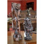 A Chinese hardwood carving, of an emaciated elder, he stands supported by his staff,