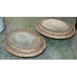 A pair of 19th century giltwood and gesso oval foot stools, fruiting vine and beaded borders,