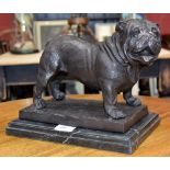 A bronzed figure of a bulldog on marble plinth.