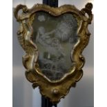 A Venetian Rococo giltwood cartouche shaped looking glass,