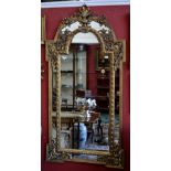 A modern large gilt framed mirror, arched top decorated flora and harebells throughout.