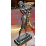 A bronzed figure of a lady disrobing.