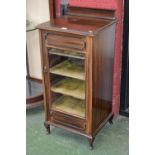 An Edwardian mahogany music cabinet, glazed door enclosing lined shelving, c.