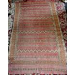 A hand woven Middle Eastern throw rug, geometric designs in hues of cream,