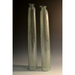 A 19th century glass cucumber straightener, of typical form, 63cm long; another, smaller,