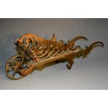 A 19th century novelty pen rest, as a wheel barrow, 25cm long, c.